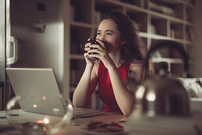 Lady drinking coffee in her office