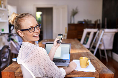 Women making notes from her phone whilst sat in the office